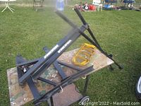 Black Yakima truck rack on a wooden table outdoors, showing rack frame and Yakima branding