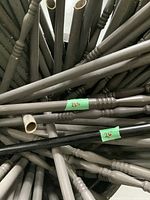 Photo showing multiple metal balusters with some marked 52 inches and 26 inches lengths, featuring smooth and turned spindle styles