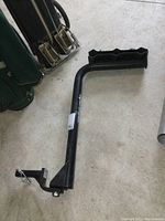 Black metal arm component of the Sportrack bike rack with mounting base and pin lock.