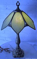 Full front view of lamp unlit showing shade shape and base details