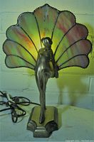 Front view of lamp illuminated against light-colored background