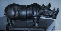 Front and side view of the right-side rhinoceros bookend placed on a flat surface.
