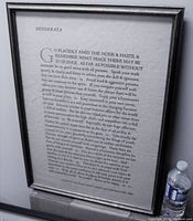 Full view of framed Desiderata poem print with the word 'Desiderata' at top and black wood frame surrounding the print.