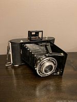 Side angled view of Adox Vario folding bellows camera showing bellows extended and top viewfinder.