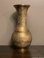Front profile view of the brass vase showing engraved pattern details and shape.