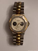 Front view showing watch face with two subdials, Gruen Sport branding, and two-tone bezel.