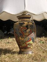 Close-up of the hand-painted Satsuma style ceramic lamp base showing detailed Japanese figure and design.