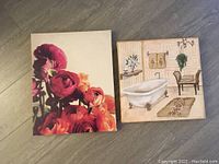 Photo of two canvas wall art pieces: left showing floral design, right a vintage bathroom scene.