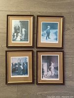 Four framed Paul Peel prints laid out in a 2x2 arrangement on a wood floor. Each print depicts a child or children in gentle, classic scenes. Frames are brown with beige mats.
