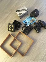 Overview photo showing all items together including camera, binoculars, trays, and decorative boxes