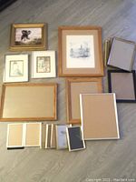 All frames and artwork laid out showing variety and quantity.