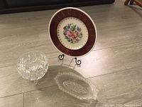 Entire lot with candy dish, decorative plate, and crystal serving tray arranged on floor