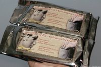 Two sealed 500g packages of natural modeling clay in silver foil with classical sculpture label