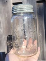 Front view of the transparent glass jar showing the embossed crown emblem and text 'Made in Canada' and 'Crown'.