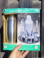 Photo of box front showing stainless steel cocktail shaker and bar tool set with rotating stand, 7 pieces included, 18/10 stainless steel.