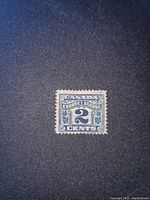 Front side of the Canadian 2 cent excise stamp showing blue color and text.
