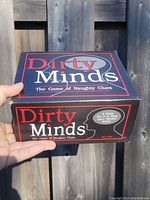 Front side of the Dirty Minds board game box with large title text and game tag line.