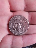 Reverse side of 1985 Kennedy Half Dollar coin showing Presidential Seal and inscriptions