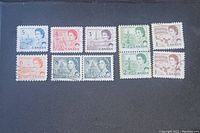Lot of 10 vintage Canadian Queen Elizabeth II stamps in various denominations and colors, displayed on a dark background.