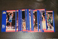 Spread of vintage basketball cards featuring Kevin Brooks in Denver Nuggets uniform, showing front side with action shots.