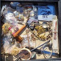Top view of the 14x14 inch box showing assorted antique and jewelry items including coins, cutlery, and decorative pieces in plastic bags and loose.