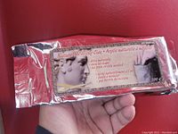 Front side of foil-wrapped block of Sigal natural modeling clay showing product name, weight 500g, and image of classical sculpture bust.