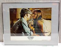 Framed 14 x 18 inch lobby card for the 1973 movie Slither featuring a man and woman in an intimate pose, autographed by James Caan.