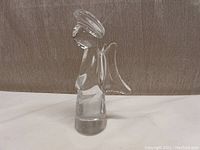 Side profile of the 7-inch clear crystal angel figurine showing halo, wings, and body shape.
