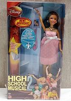 Front view of Disney High School Musical 2 Gabriella doll in original sealed box, showing doll wearing pink dress and accessories.