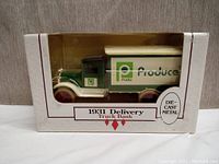 Side view of the Ertl 1931 delivery truck bank in original packaging showing Publix logo and details.