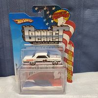 White Hot Wheels Michigan 65 Pontiac GTO die-cast car in clear blister on original unopened Connect Cars collectible card with American flag design and stars. Vehicle has Michigan and number 26 decals on side and racing stripes on hood and roof.