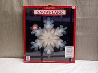 Box showing front of lighted snowflake decoration with size and usage details