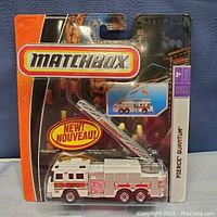 Full packaging front showing sealed Matchbox Pierce Quantum fire truck with ladder on backside card.