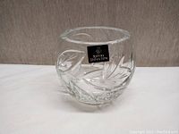 Clear crystal rose bowl or dish with detailed leaf and geometric cuts and Royal Doulton label sticker on front.