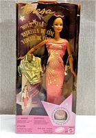 Front view of Teresa Movie Star Doll in box showing doll in pink gown holding metallic jacket, with pink sunglasses on doll's head and clear plastic window of box.