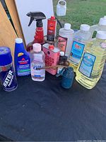 Wide view of assortment of bottles including lamp oil, glass wax, water proofer, and other cleaning liquids