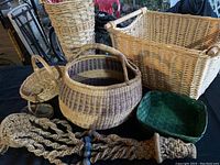 Photo showing six items: five baskets of various sizes and shapes plus one handmade macramé hanger with wooden beads.
