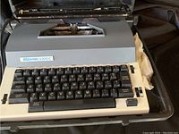 Front view of Swintec 3300C electric typewriter with keyboard and label visible