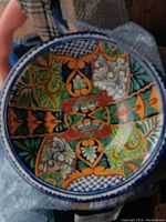 Overhead view of the large Mexican pottery bowl showing full interior hand-painted floral and geometric pattern in multiple vivid colors.