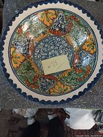 Top view of the large Mexican pottery bowl showing detailed colorful floral and geometric patterns.