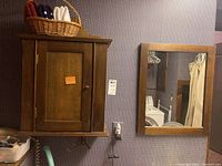 Medicine cabinet and wall mirror mounted on wall, showing size and relative placement.