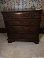 Front view of Pennsylvania House wooden chest with 4 drawers, metal handles on drawers, and keyhole escutcheons.