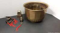 Large brass bowl, Asian bells, and incense burner together showing size and assortment