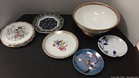 Collection of assorted plates and Winton pedestal bowl arranged on a surface