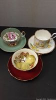Three cups and saucers displayed