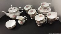 Full set overview: teapot, creamer, sugar bowl, cups and saucers