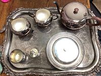 Full set on silver tray showing teapot, creamer, sugar bowl, covered dish, and small goblets