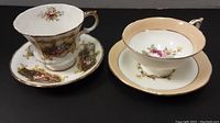 Both Paragon tea cup and saucer sets side by side, showing different floral and gold designs