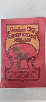 Photo of the catalog cover showing the title Quaker City Grinding Mills by A.W. Straub Co., Philadelphia, PA, with a red and yellow ornate design and image of a grinding mill machine.