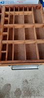 Top view of the antique wooden watch company parts tray showing multiple wooden compartments for organizing small parts.